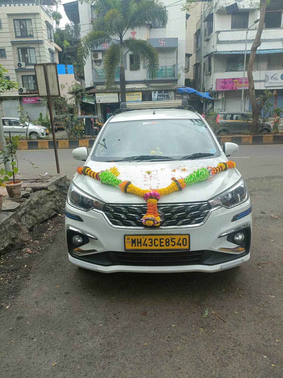 Divya Tours & Travels’ white Maruti Ertiga, MH 43 CE 8540, garlanded on its first day