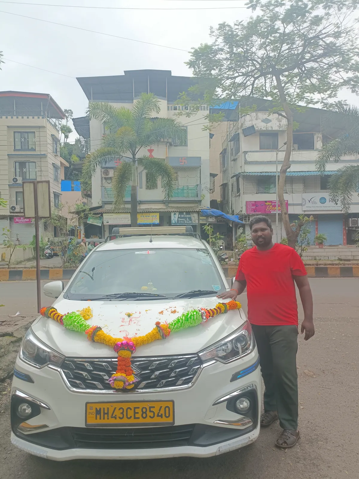 Rajkumar Rathore of Divya Tours & Travels with the white Ertiga on its first day