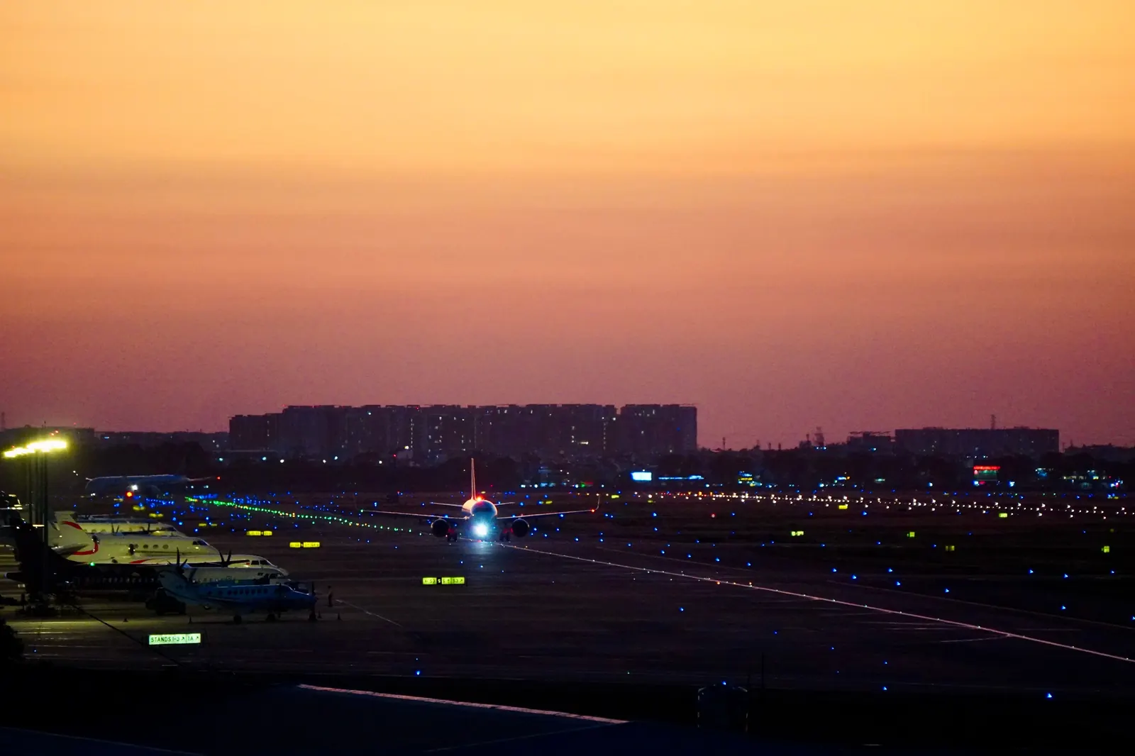 Airliner on an illuminated runway at night